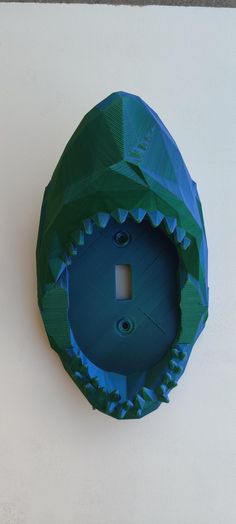 a blue and green object that looks like a shark's mouth