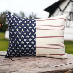 an american flag pillow sitting on top of a wooden table