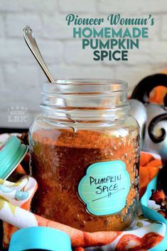 a jar filled with pumpkin spice sitting on top of a table next to other items