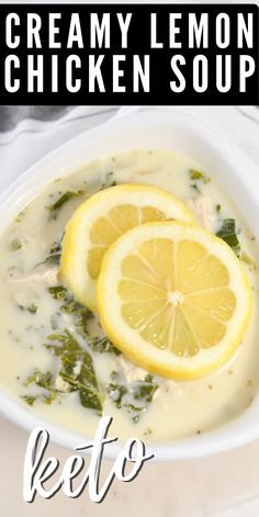 a white bowl filled with chicken soup and lemon slices