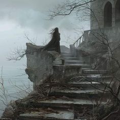 a woman with long hair is standing on some stairs by the water in front of an old castle