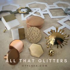 all that glitters are on the floor next to some gold and white objects,