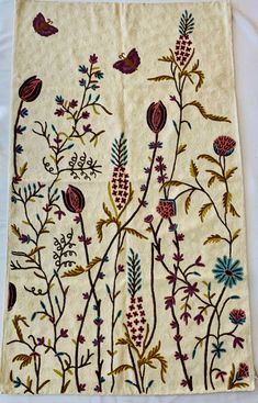 an embroidered cloth with flowers and birds on it