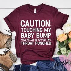 a t - shirt that says caution touching my baby bump will result in you getting throat punched