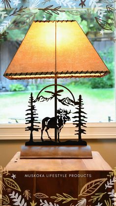 a lamp that is sitting on top of a wooden table in front of a window