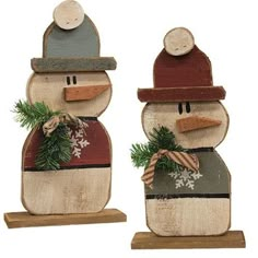 two wooden snowmen with hats and scarfs