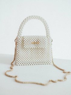 Pearl beaded bags are luxurious and sophisticated accessories that are suitable for formal occasions, such as weddings, proms, and black-tie events.  However, they can also add a touch of glamour and femininity to more casual outfits and can be worn for a night out or a dinner party. The bag is woven from fishing line, which can withstang 25 kg. It is very reliable as it closes with a magnetic clasp.  100% handmade Material: acrylic pearl beads 8 mm  We offer 2 sizes of this handbag: 1 Size:  > Pearl Handbag, Prom Purse, Bridal Handbags, Wedding Purse, Purse Gift, Pearl Bag, Beaded Bag, Luxury Purses, Wedding Bag