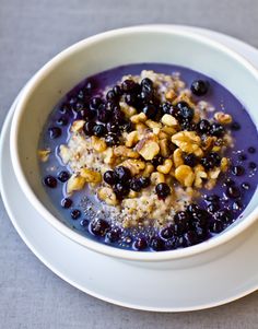 a bowl of oatmeal with blueberries and walnuts