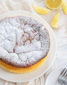 a powdered sugar covered cake sitting on top of a white plate