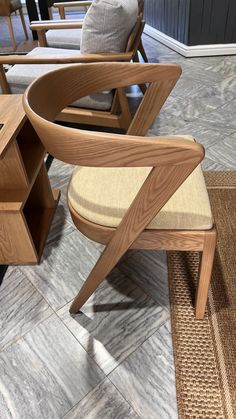 a wooden chair sitting on top of a tile floor