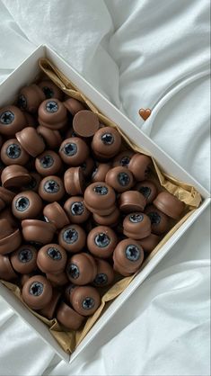 a box filled with lots of chocolate buttons