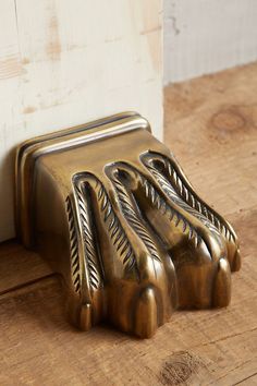 a metal object sitting on top of a wooden floor