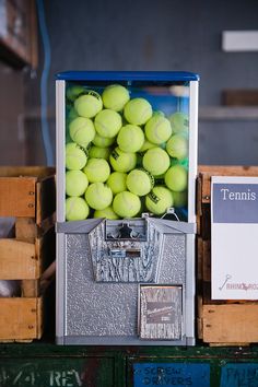 tennis balls are stacked in a machine to be sold