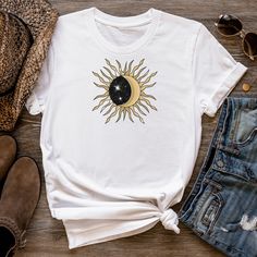 You'll love this celestial themed t-shirt, which shows your Boho inner side It comes in a variety of colors and would make an excellent gift for yourself or someone else. This is a super soft short sleeve tee with a beautiful sun and moon graphic. The tee is available in black, grey, navy and white. Makes an awesome gift! This classic unisex jersey short sleeve tee fits like a well-loved favorite. Soft cotton and quality print make users fall in love with it over and over again. These t-shirts h Celestial Crew Neck Tops For Summer, Celestial Cotton Tops For Summer, Cotton Tops With Sun And Moon Design For Summer, Celestial Graphic Print Tops For Summer, Celestial Style Cotton Tops With Short Sleeves, Summer Celestial Graphic Print Tops, Celestial Graphic Print Summer Tops, Celestial Short Sleeve Cotton Tops, White Graphic Tee With Moon Print