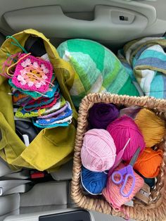 yarn and crochet items in the back seat of a car