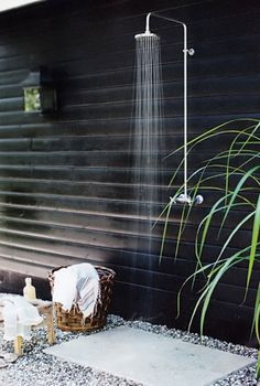 an outdoor shower with water coming from the faucet