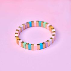 Pretty in pastel all summer long. The Bright Tides Bead Stretch Bracelet features enamel-plated beads in nine pantone summery shades. The total length of the bracelet is 6.25''. - Strung on thick elastic nylon cords- Beads are 12mm (L), 8mm (H)- Gold beads are brass base with gold plating- Total length of bracelet: 6.25 inches Tech Accessories Gadgets, Cloud Stickers, Pura Vida Bracelets, Enamel Beads, Chapstick Holder, Enamel Bracelet, Girly Jewelry, 50th Gifts, Beaded Stretch Bracelet