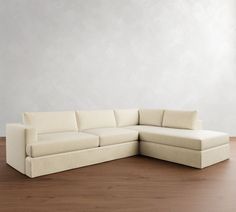 a white couch sitting on top of a wooden floor