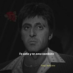 a man with a red rose in his hair is looking at the camera and has a quote on it