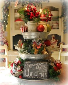 three tiered christmas tree with ornaments on top