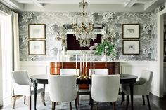 a dining room table with chairs and a chandelier