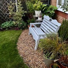 a wooden bench sitting in the middle of a garden