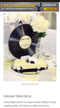 a table with a record and flowers on it