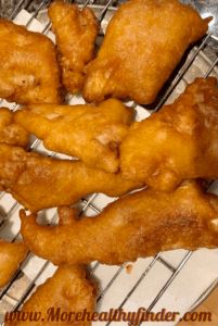 some fried food is sitting on a metal rack