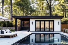 a pool house with an outdoor lounge area next to it