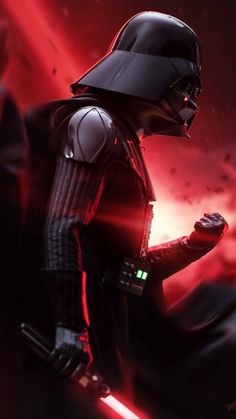 darth vader standing in front of a red light with his hand on his hip