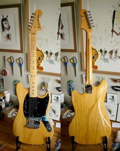 two guitars sitting on top of a wooden floor