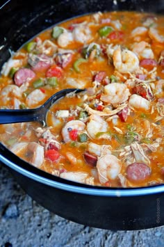 a bowl of soup with shrimp and vegetables