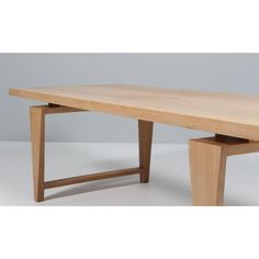 a wooden table sitting on top of a white floor