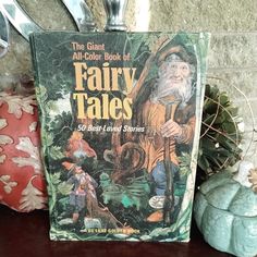 the giant all - color book of fairy tales sits on a table