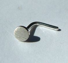 This disc is a little thicker than the 4mm disc nose studs that I make. This is a tiny sterling silver disc, about 3.2mm, that I soldered onto 20 gauge sterling silver stem.   A simple bend makes it easier to get in and out. I gave it a brushed finish. I can also send it unbent, so that you can have it custom fitted by your own local body piercer.  Just tell me the length that you need. I can use thinner wire if 20 gauge is too thick for your piercing. Here are more options: https://www.etsy.com Silver Nose Stud, Nose Screw, Nose Studs, Nose Ring Stud, Nose Stud, Body Jewellery, Nose Piercing, Custom Fit, Body Jewelry