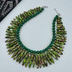 "PLEASE NOTE: The color may be slightly different from the pictures on different devices. This beautiful Green Yellow Jasper and Malachite Statement Necklace is completely handmade with high quality. Matching earrings are available. This gorgeous Jasper Statement Necklace goes with everything and everywhere, holiday party or after work with friends. Necklace made from green malachite round beads 10 mm, and green yellow graduated jasper 18~46 x 4~8 x 6~9 mm. The Necklace length is 16.5\" short la Green Malachite Beaded Necklaces With Natural Stones, Green Malachite Beaded Necklace With Natural Stones, Handmade Green Malachite Beaded Necklace, Green Beaded Necklace With Natural Stones, Green Beaded Necklace With Faceted Beads, Unique Green Beads With Natural Stones, Adjustable Green Malachite Beaded Necklace, Adjustable Green Malachite Beaded Necklaces, Friends Necklace