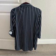 Brand New Navy Blue Shirt With White Vertical Stripes. Has Two Functional Pockets On The Front And 3/4 Cuffed Sleeves. Lightweight And Very Soft Material. 100% Polyester. Questions? Leave A Comment Below! Casual Navy Button-up Blouse, Navy Collared Office Top, Navy Workwear Tops With Button Closure, Navy Collared Top For Office, Casual Striped Blouse For Business Casual, Navy Button Closure Top For Work, Striped Collared Top, Striped Button-up Tops For Business Casual, Striped Collared Top For Office