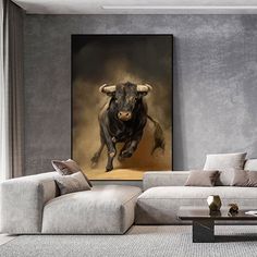 a living room with a couch, coffee table and cow painting on the wall above it