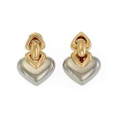 These authentic Bulgari earrings are finely crafted from 18k yellow and stainless steel with a fine polished finish featuring two small double gold hearts attached to a larger solid white gold heart with a polished finish. The pair comes with post omega backs and are fully signed with Bulgari along with the gold content.  Material: 18k yellow and stainless steel       Hallmark: Bulgari 750 Made in Italy Measurements: 0.97" long x 0.70" wide x 0.30 high Weight: 21.3 grams Stock#: 67182 Bulgari Earrings, Gold Hearts, Double Heart, Clip Earrings, Gold Heart, Heart Of Gold, Clip On Earrings, Hallmark, Jewelry Earrings Dangle