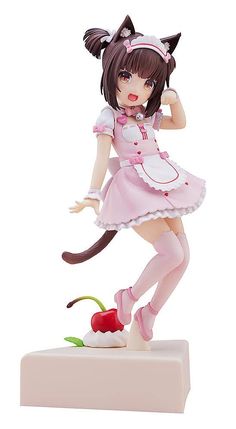 an anime figurine is posed on top of a white block with a cherry in her hand