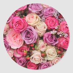 a bunch of pink and purple roses in a round sticker on a white background