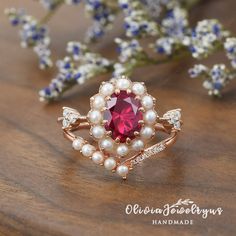 a close up of a ring on a table with flowers