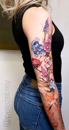 a woman with a flower tattoo on her arm