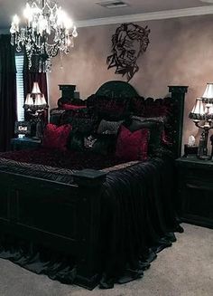 a bedroom with a bed, chandelier and two lamps