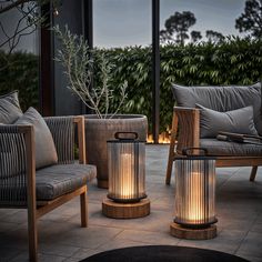 a couple of chairs sitting next to each other on top of a stone floor covered patio