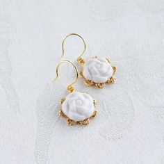 We love all the floral-inspired design. These handcrafted porcelain camellia earrings not only can add details for your everyday outfit, but also can perfectly pair with your evening dresses. Earrings are made of porcelain flowers; gold-pated brass; gold-plated silver ear hooks. The mini version - Mini Camellia Flower Charm Earrings, is also available. Gold- or silver-plated colour will fade over time. This is a normal result from long-term wear and contact with air. However, with careful handli Camellia Flowers, Camellia Flower, Handmade Porcelain, Porcelain Jewelry, Porcelain Flowers, Everyday Outfit, Ear Hook, Online Earrings, Flower Charm