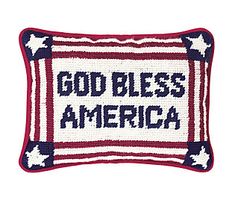 a red, white and blue pillow with the words god bless america on it