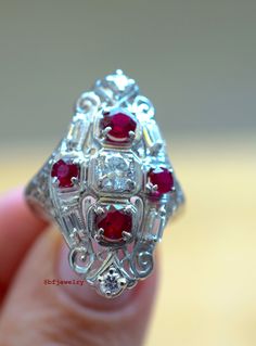 Metal: 14K White Gold Stone: Diamond And Ruby Shape: Round and Baguette Diamond Total Weight: .41 Carats Ruby Weight: .81 Carats Ring Size: 7 Sizable: Yes. Please state size in size/personalization box. Weight of entire piece with stones: 4.60 Grams Measurements of Top Part Of Ring: 25 mm Long 14 mm Wide Measurements of Band: 2 mm Customization: We can custom make this ring in any metal or with any gems. Please inquire if interested. Luxury Silver Ruby Ring With Baguette Cut, Art Deco Ruby Ring With Diamond Cut For Wedding, Art Deco Ruby Jewelry With Brilliant Cut, Luxury Rectangular Ruby Ring For Wedding, Anniversary Hallmarked Platinum Ruby Ring, White Gold Art Deco Ruby Ring For Wedding, Art Deco Oval Ruby Ring For Anniversary, Art Deco White Gold Ruby Ring For Wedding, Art Deco Ruby Gemstone Ring For Wedding