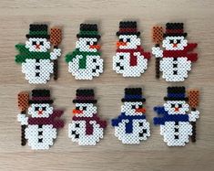 six snowmen made out of perler beads