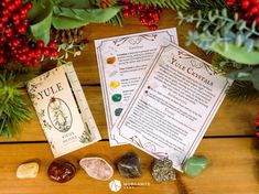 the true christmas book is next to some rocks and greenery on a wooden table